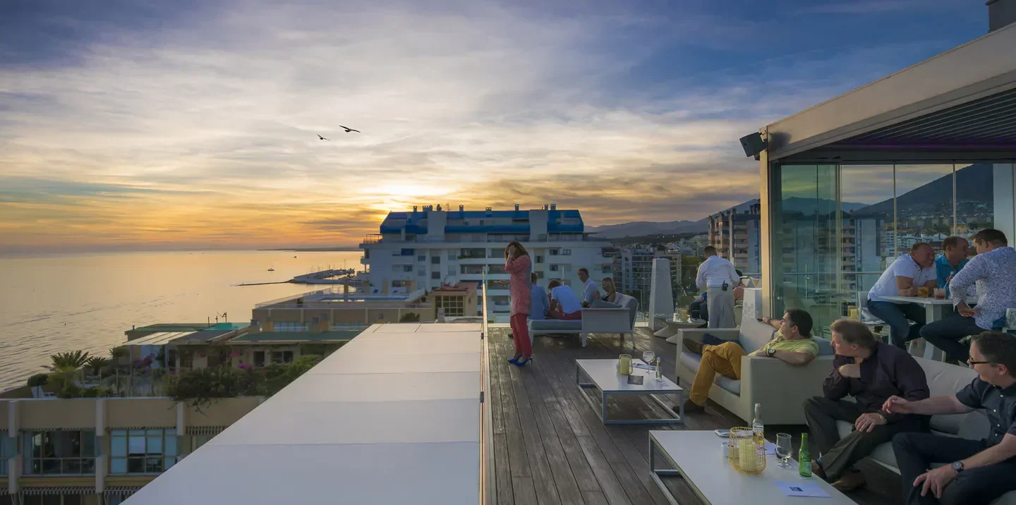 Sunset view at Bellevue Rooftop Bar in Marbella, with guests enjoying drinks