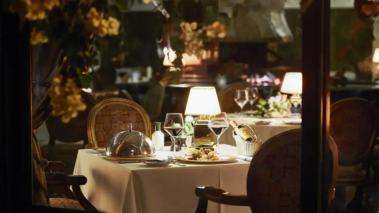 Romantic table setting at El Grill in Marbella, Spain, with wine and fine dining.