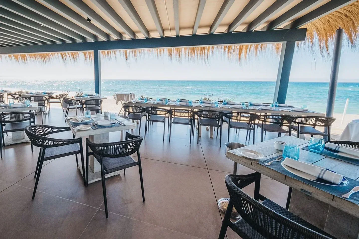 Seaside dining at La Milla restaurant in Marbella, with ocean views and stylish tables.