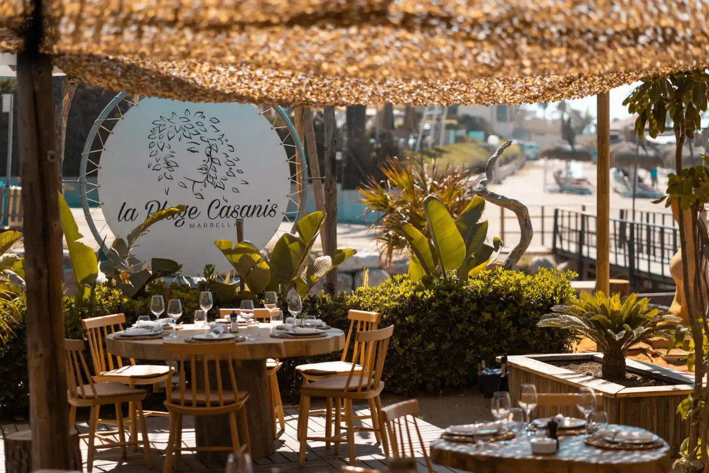 Outdoor dining at La plage casanis in Marbella, Spain, featuring elegant table settings.