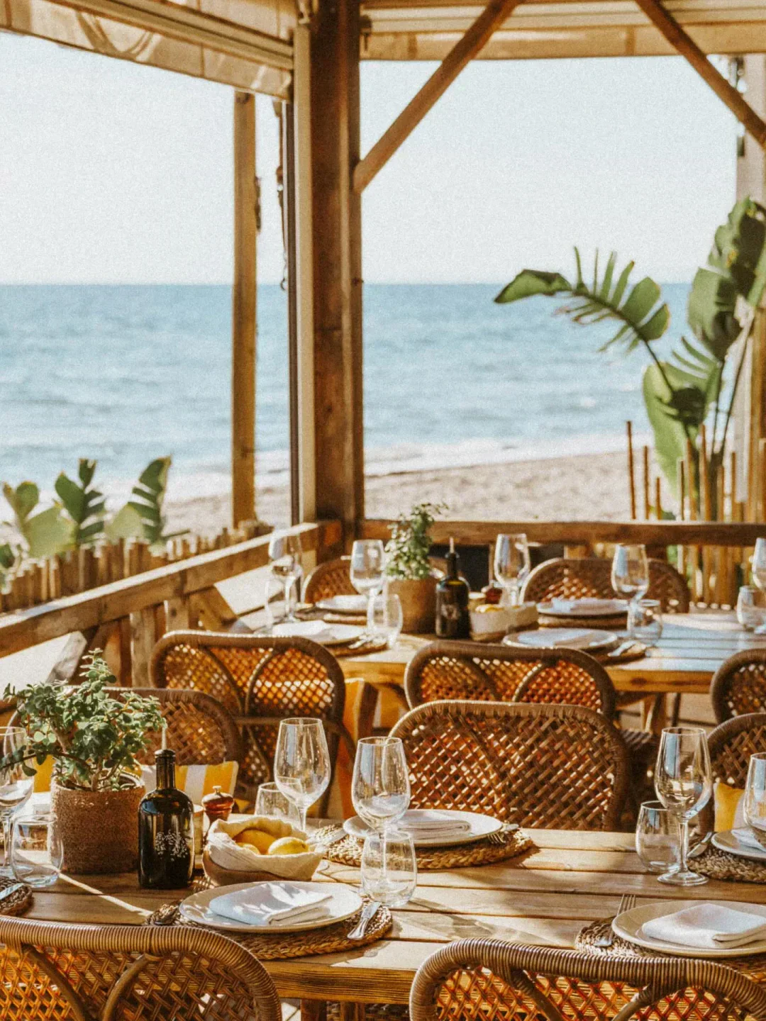 Beachfront dining at La plage casanis, Marbella, with views of the ocean and elegant setup.