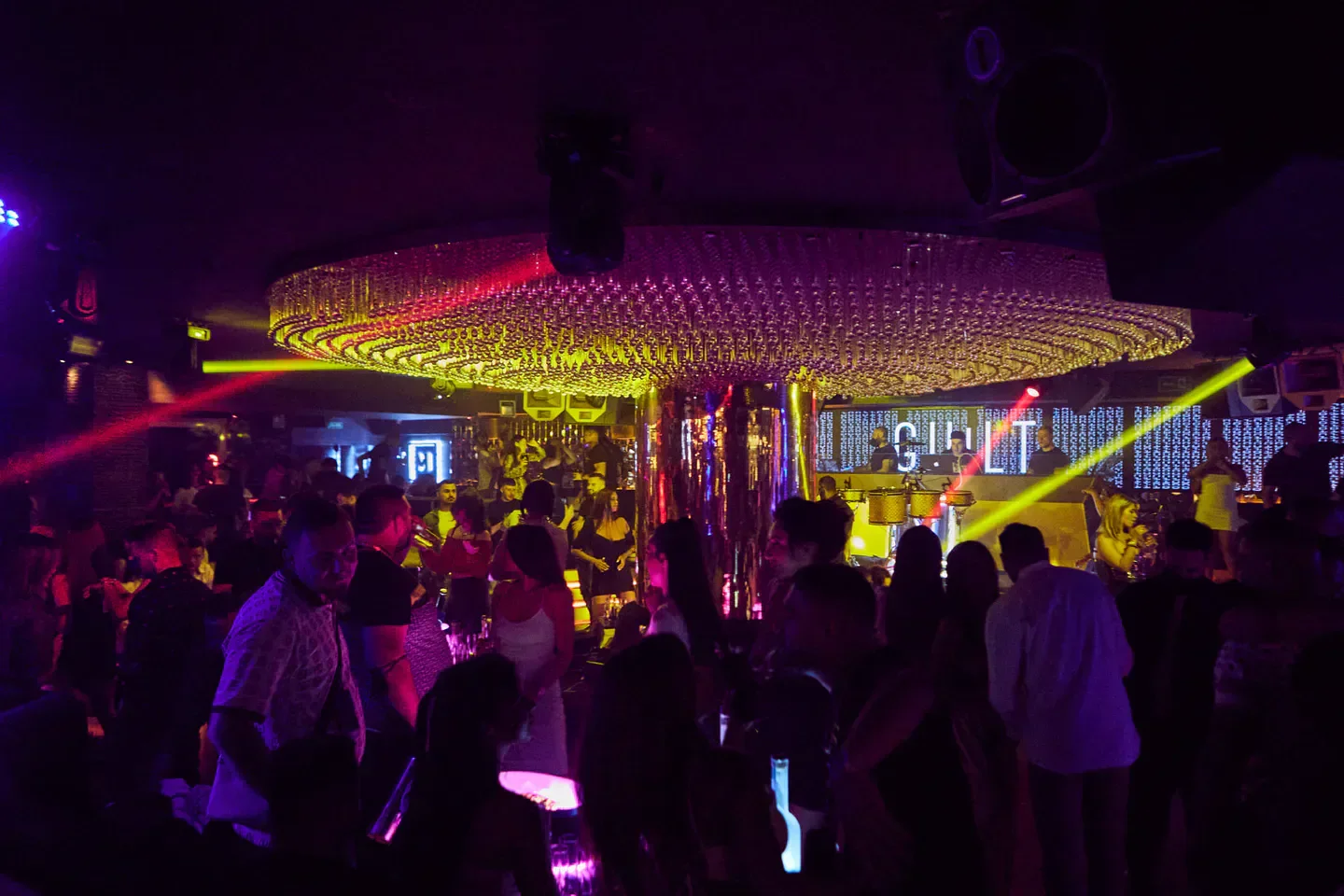 Inside Mirage nightclub in Marbella, a busy dance floor under a dazzling light fixture.