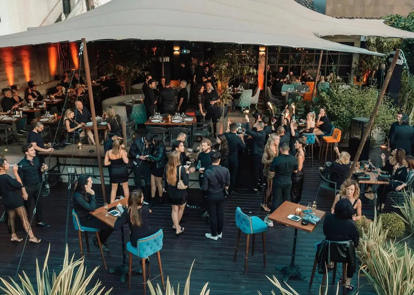 Nightclub Mosh in Marbella, elegant crowd enjoying the outdoor terrace party scene.