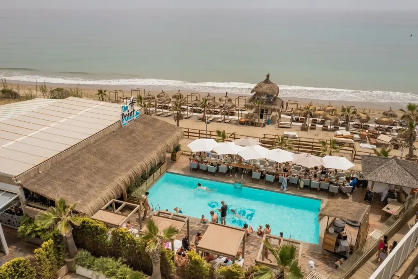 Aerial view of The Point beach club in Marbella, featuring pool and dining area